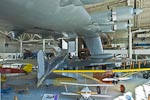 A rear view of the Douglas DC3-A from the top of the stairs at the entrance of the Spruce Goose.  The white wooden-prop biplane in the foreground is an Oldfield "Baby Great Lakes" and the orange monoplane to its right is a Curtiss Robin B.